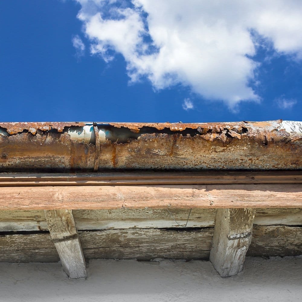 broken gutter on the roof of a house